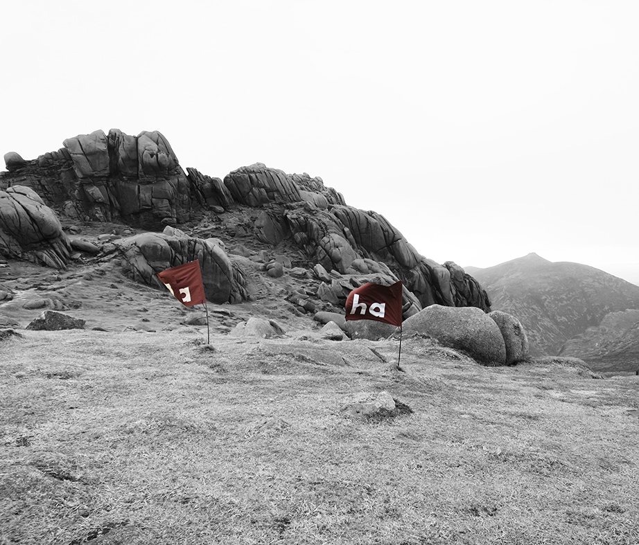 Image of two 'ha ha' flags on the summit of Bearnagh Mountain - displaying 'ha ha' partially